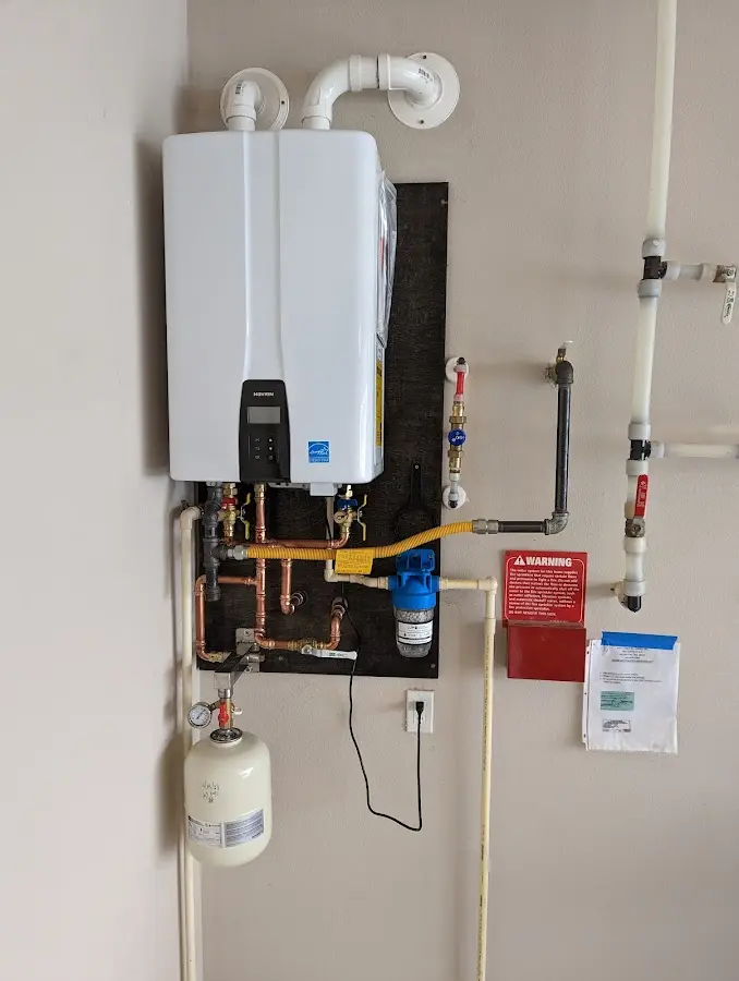 Professional plumber installing copper piping in a Woodburn home